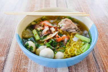Clear soup noodles with pork and vegetables and fish balls and red pork