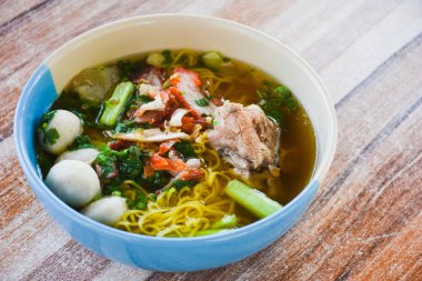 Clear soup noodles with pork and vegetables and fish balls and red pork