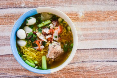 Clear soup noodles with pork and vegetables and fish balls and red pork