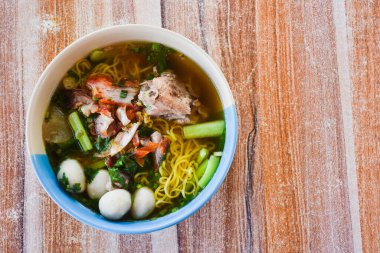 Clear soup noodles with pork and vegetables and fish balls and red pork