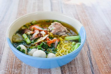 Clear soup noodles with pork and vegetables and fish balls and red pork