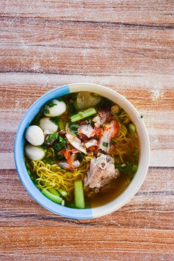 Clear soup noodles with pork and vegetables and fish balls and red pork