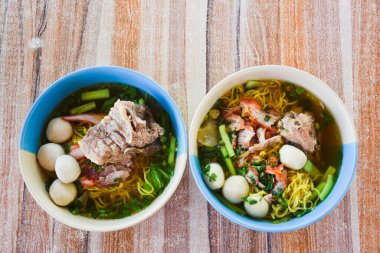 Clear soup noodles with pork and vegetables and fish balls and red pork
