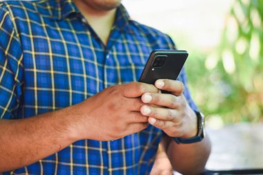 kahve dükkanında cep telefonu kullanan adam