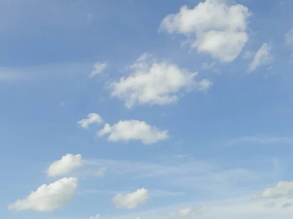 A blue sky with a white cloud at noon has a place for text.