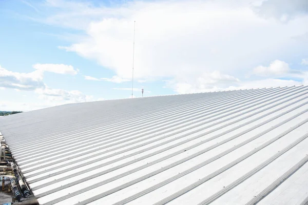 metal sheet roofing on commercial construction with blue sky