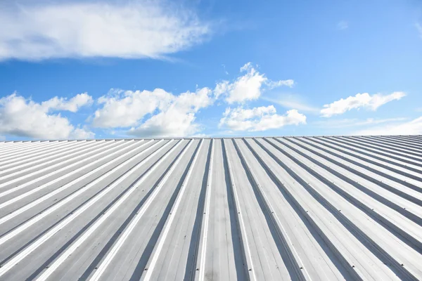 metal sheet roofing on commercial construction with blue sky