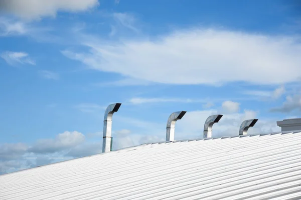 metal sheet roofing on commercial construction with blue sky