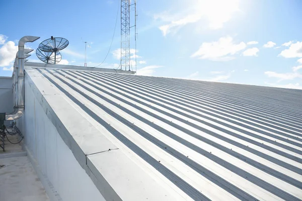 metal sheet roofing on commercial construction with blue sky