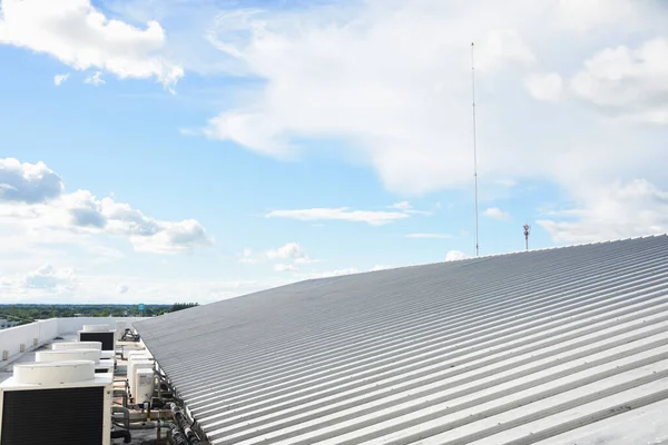 metal sheet roofing on commercial construction with blue sky