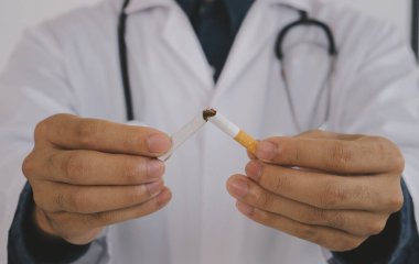Doctor breaking a cigarette and advise patients to quit smoking. International Wold tobacco day and quit smoking cigarettes concept.
