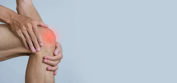 Young man suffering with knee pain.Office syndrome Concept.Health concept.copy space for text.