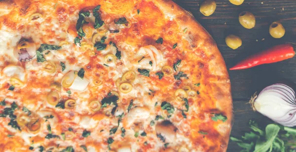 Tahta masada pizza var. Restoran ve pizzacılar için konsept promosyon şablonu. Yemek malzemeleri ve baharatlı geleneksel İtalyan pizzası. Uzayı kopyala Üst Manzara. Pankart. Pizza menüsü.