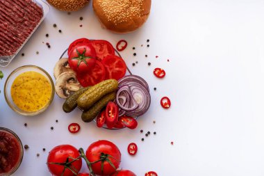 Set of different ingredients for making a burger on a white background. Cooking a burger. Homemade hambrger. Top view with free space for your text.