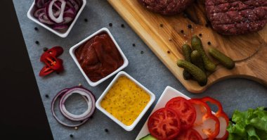A set of different ingredients for making a burger. Cooking a burger. Homemade hambrger. Top view with free space for your text.