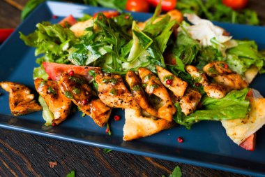 Healthy food for fitness with chicken, vegetables, herbs, spices and olive oil. High in antioxidants, minerals and vitamins. Healthy homemade chicken salad, diet food, vitamin snack.