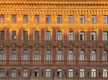 Vintage building facade with windows and balconies. Old building facade wall. Traditional architecture, St Petersburg, Russia. Historic architecture.