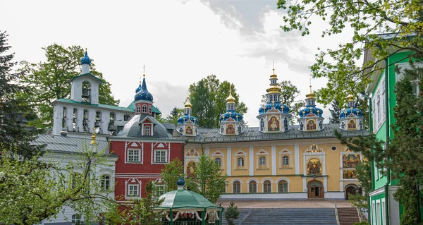 View of beautiful buildings and orthodox churches ancient Pskov-Pechersky monastery. Fortress wall and tower. Pechory, Pskov, Russia.