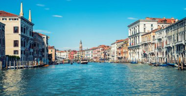 Colorful facades of old medieval houses in Venice, Italy. View on canal with boats and motorboats. Picturesque landscape. Retro vintage Instagram style filter effect.