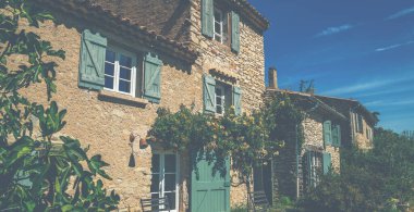 View of a beautiful house exterior wiht door and windows. Beautiful view of a traditional French country house in Gordes Provence South France. Vintage tone filter effect with noise and grain.