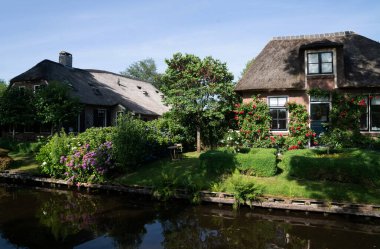 View of typical houses of Giethoorn, Netherlands. The beautiful houses and gardening city is know as 