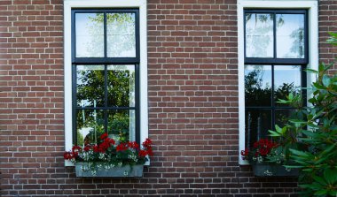 Beautiful dutch traditional houses. Brick wall with window in historic old town.