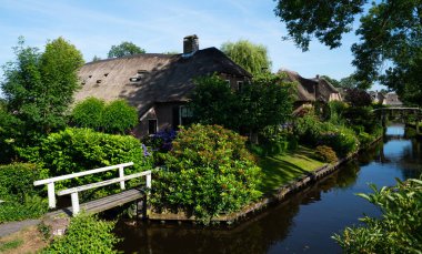 View of typical houses of Giethoorn, Netherlands. The beautiful houses and gardening city is know as 