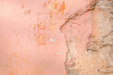Distressed pink old brick wall. Background with painted peeling plaster. Abstract grunge wall. Abstract plastered wall web banner. Design element.