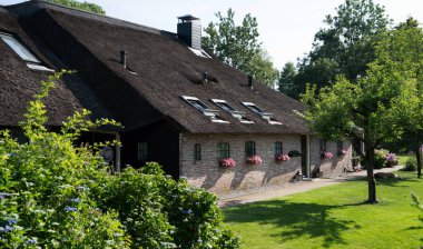 View of typical houses of Giethoorn, Netherlands. The beautiful houses and gardening city is know as 