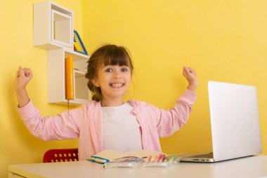 Online Preschool Classes. Excellent online learning for kids. Happy schoolgirl learning online.