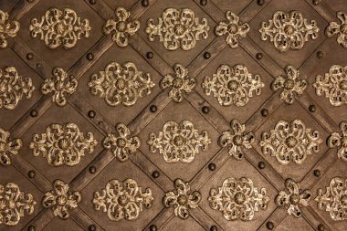 Detail of a medieval gate with metal decoration