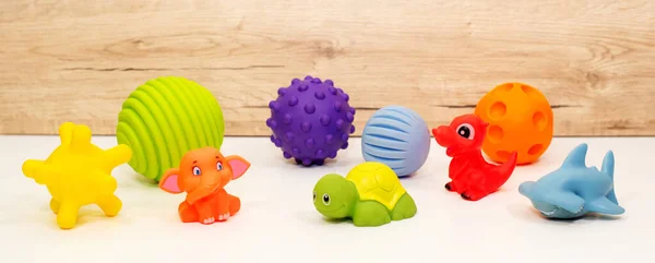 Beyaz bir masada çocuk lastik oyuncakları koleksiyonu. Yakın plan. Pankart.