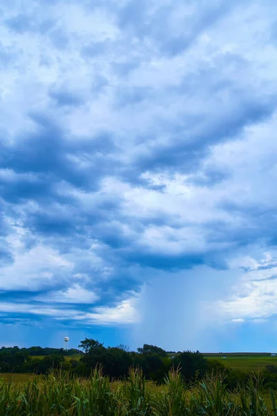 Corn fields and water tower in dark ominous clouds — Stock Photo, Image