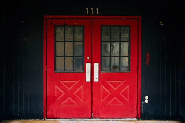 Doppie porte rosse per l'edificio 111 con pannelli neri — Foto Stock