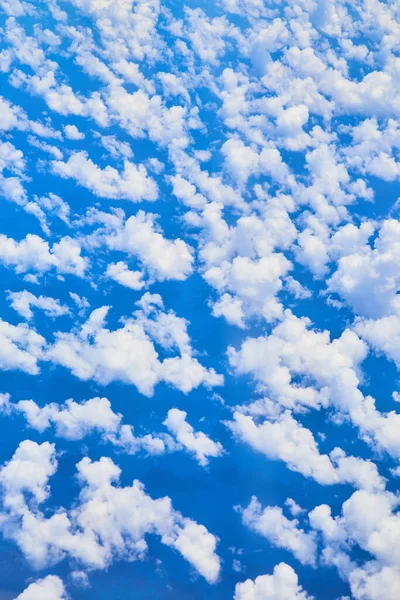 Aerial view above ocean with scattered small white clouds — Stock Photo, Image