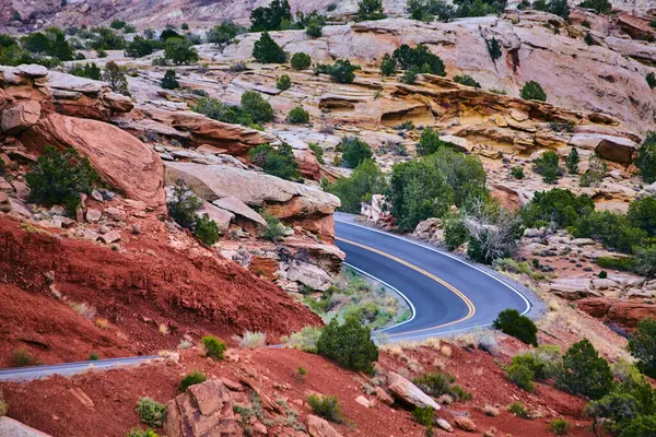 Estrada panorâmica curvando-se firmemente através do deserto de areia vermelha e grandes rochas — Fotografia de Stock