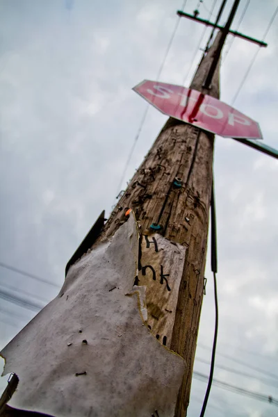 Old rusty telephone line with Stop sign — Stock Photo, Image