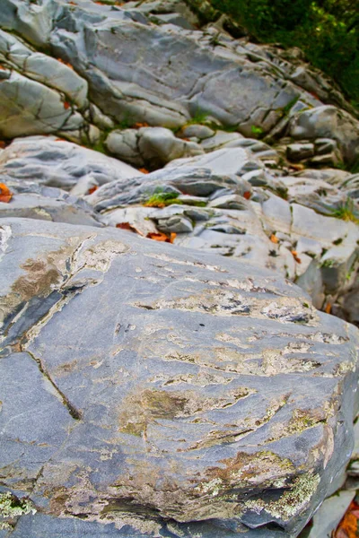 Gray weather beaten rocks on top of gray weather beaten rocks — Stock Photo, Image