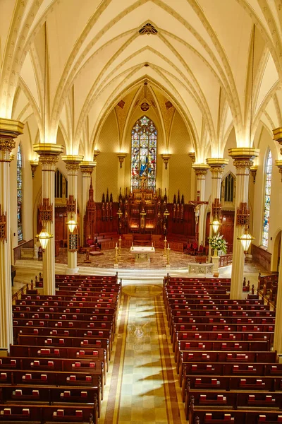 Interno bianco di una cattedrale dal balcone che mostra le panche e l'altare e l'altare di vetro colorato nel santuario — Foto Stock