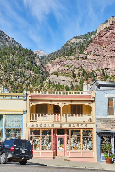 Negozio di roccia negozio in una piccola città con montagne sullo sfondo — Foto Stock