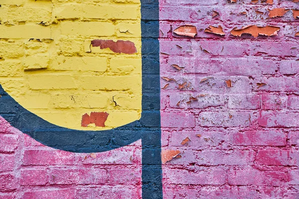 Close up of red, black, and yellow graffiti on brick — Stock Photo, Image