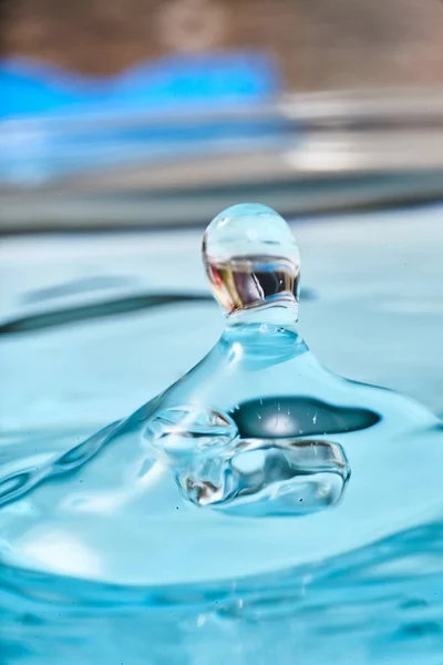 Aqua blue waterdrop with mysterious reflection — Stock Photo, Image