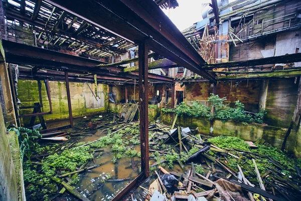 Inside large abandoned building with flooding and collapsed floors — Stock Photo, Image