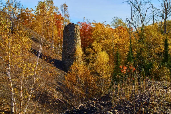 Vanha siilo hylätystä kaivoksesta nähty syksyllä metsäisellä alueella — kuvapankkivalokuva