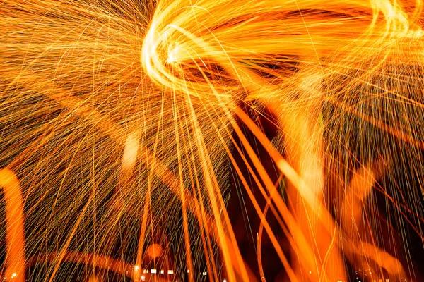 人間のシルエットと鮮やかなオレンジ色の火花の回転円 — ストック写真