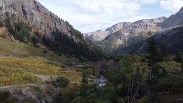 Aerial through beautiful valley tucked between two mountain ranges — Stock Video
