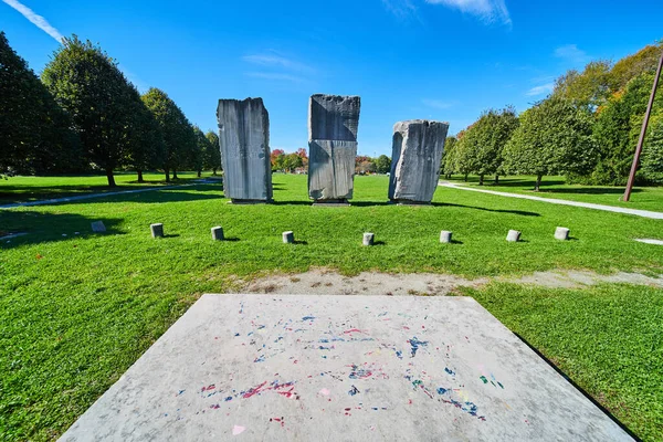 Open grass field with three large stone obelisk monuments — Stock Photo, Image