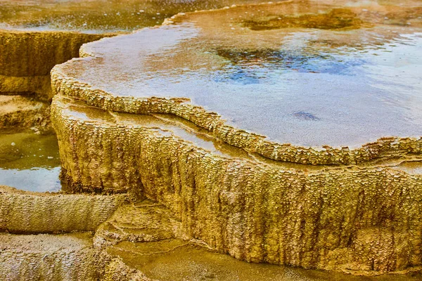 Image of Detail of texture and water filling terrace in Yellowstone hot spring