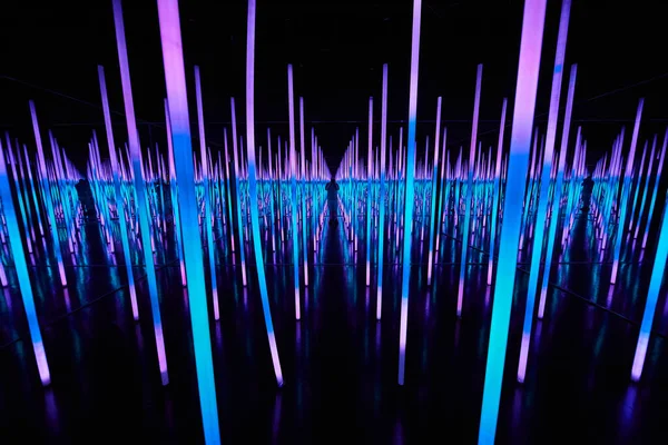 Image of Blue and purple LED light poles in infinity mirror room