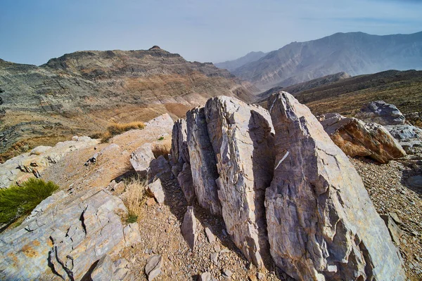 Image of Walking path on mountain top winding through boulders